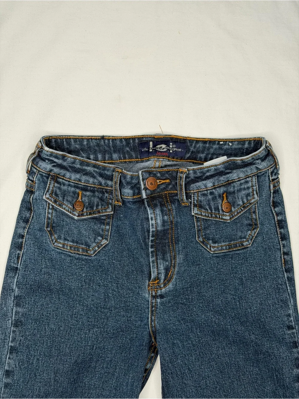 Vintage mid-wash blue denim l.e.i. bootcut jeans for girls.
